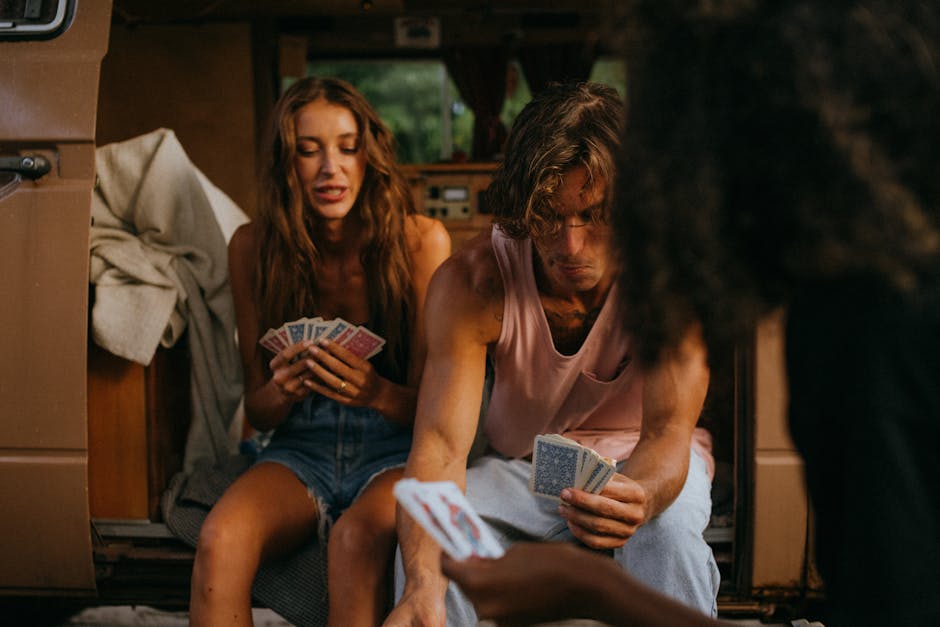 A group of friends playing cards in a cozy vintage camper. Perfect for travel and adventure themes.